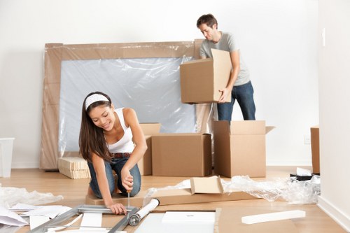 Professional movers carrying furniture during a local relocation